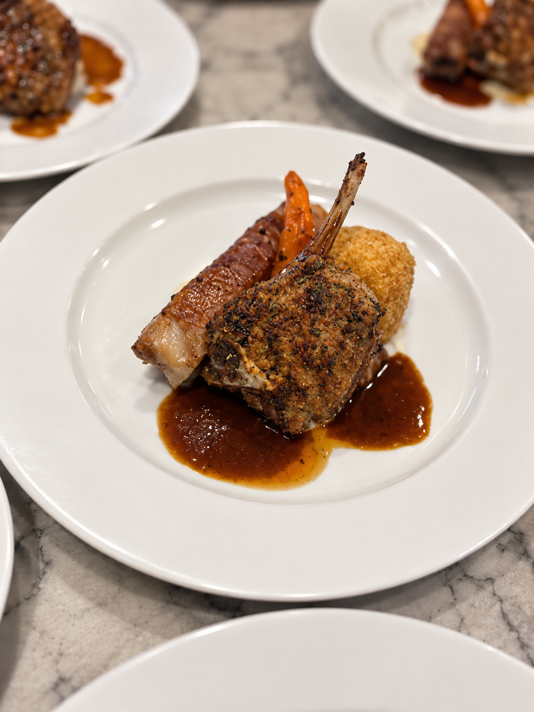Herb-crusted lamb cutlet plated with precision